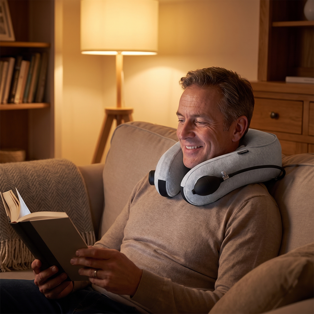 Man relaxing with the neck massager while reading